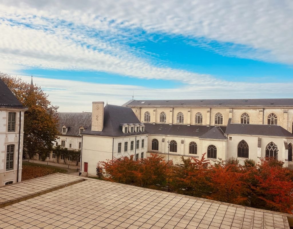 Old building on a square in France on a cloudy day.