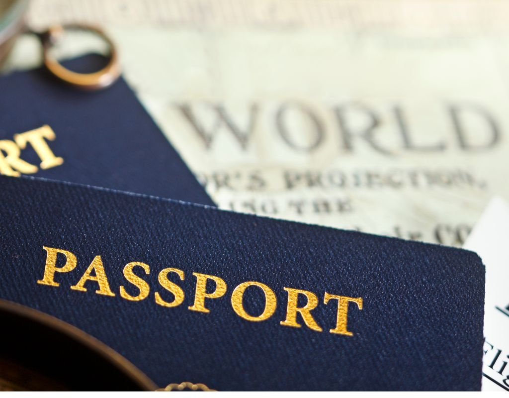 A close-up of a dark passport laid on top of a world map background, symbolizing international travel. Many of the best countries for expats offer welcoming visa options and smooth citizenship processes.