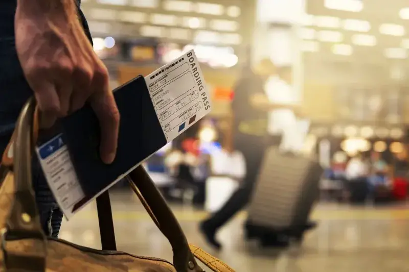 A close-up of a dark passport laid on top of a world map background, symbolizing international travel. Many of the best countries for expats offer welcoming visa options and smooth citizenship processes.