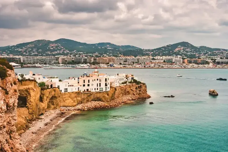 The Spanish coastline and its turquoise waters on a cloudy day.