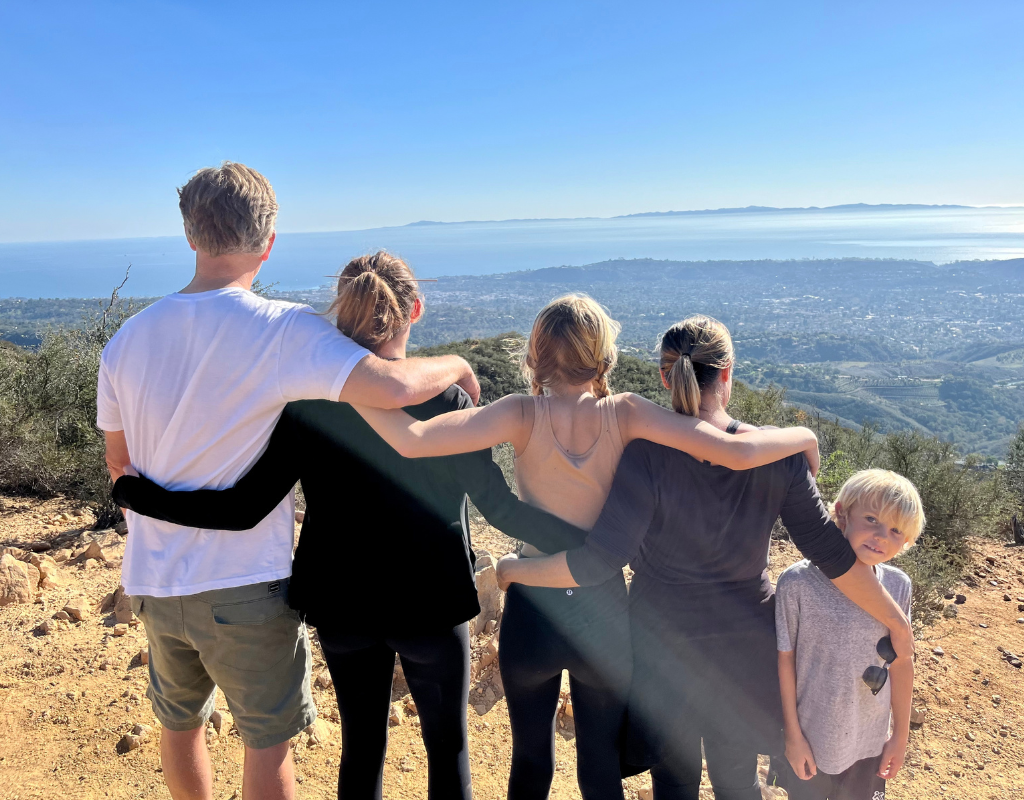 Digital nomad families spend time together visiting the world. Here is Colleen's family looking down on the bay in Mallorca after an afternoon of hiking.