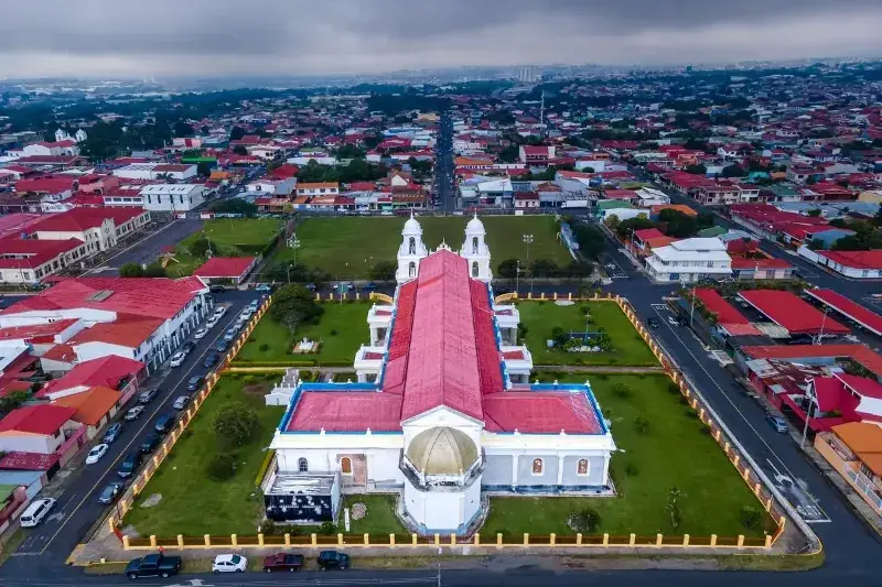 The main church in Heredia  and the surounding neighbourhood roof tops as seen from above.