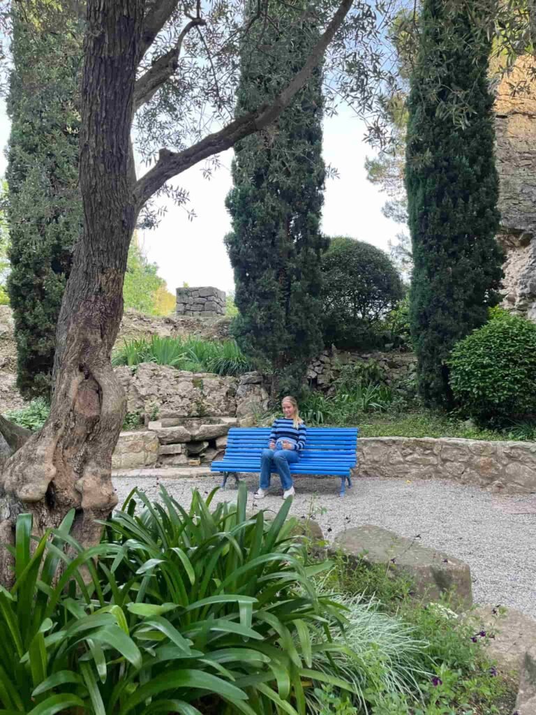 A blue bench in a park at Girona Spain.