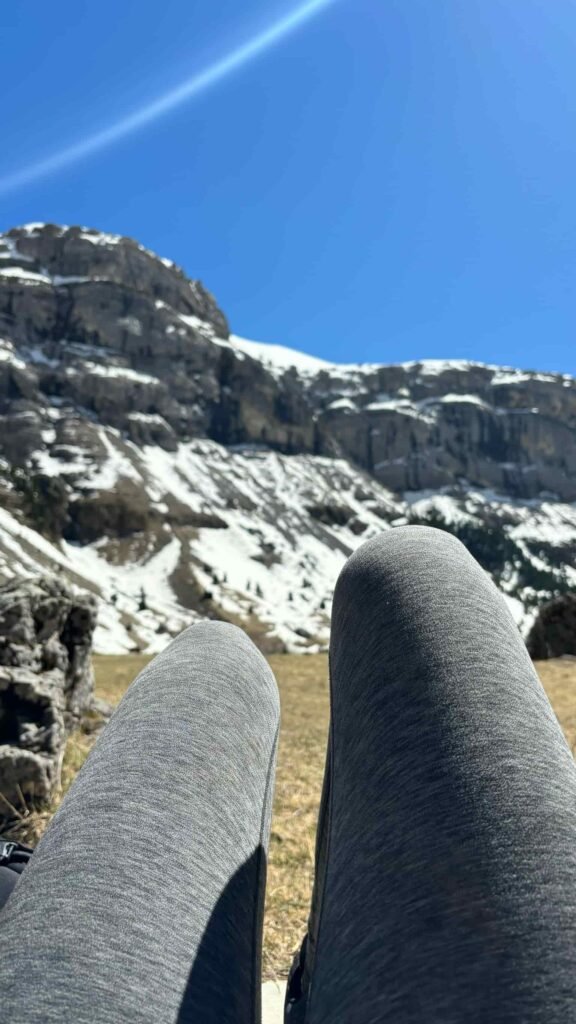 Woman legs and the view of the Spanish Pyrenees on a beautiful sunny day.