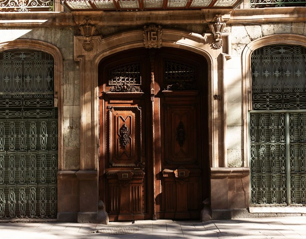 An ornate wooden door with decorative iron details on a historic building, reflecting the charm and architectural beauty in Mexico.