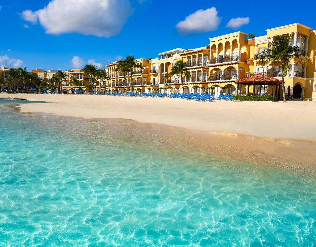 A pristine beach resort with vibrant turquoise water and sunny skies, a destination often considered when wondering, "Is It Safe to Move to Mexico?" Yes, it is!