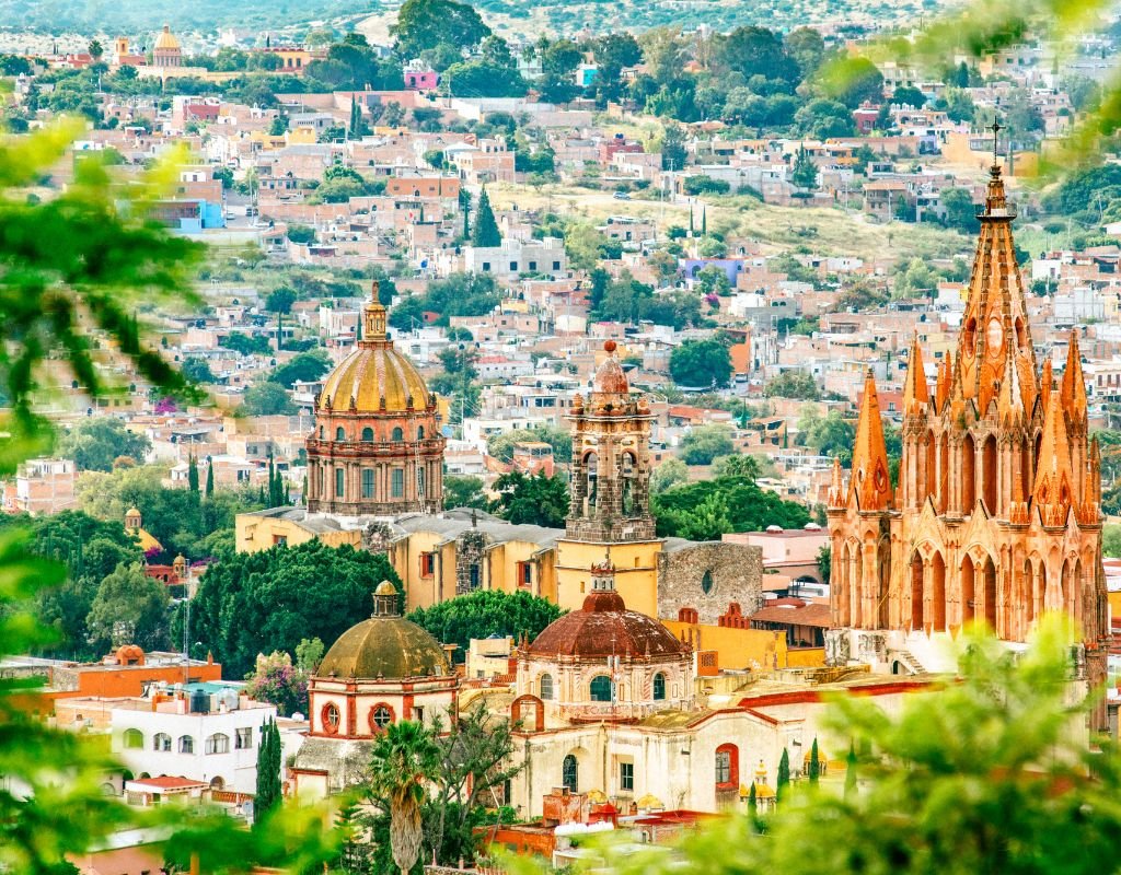 A vibrant cityscape with ornate domes and intricate facades, offering a picturesque view of Mexico’s architectural beauty.