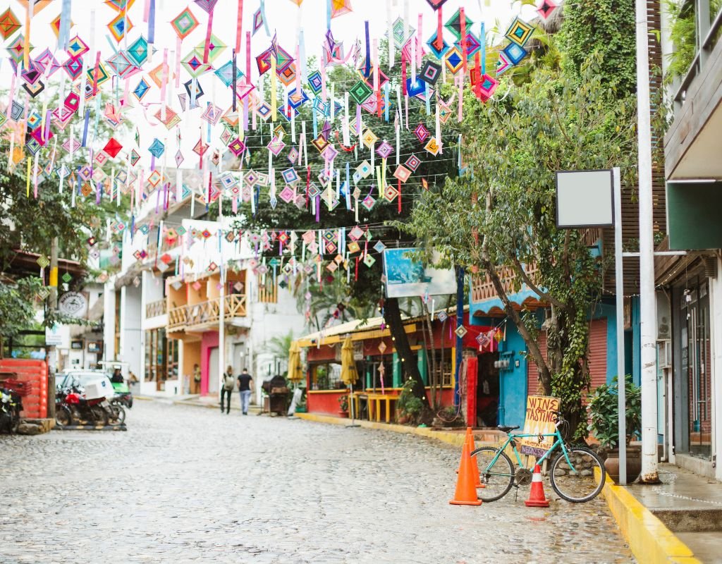 A festive street scene with handmade decorations and local businesses, illustrating the creativity and vibrancy of Mexico’s towns.