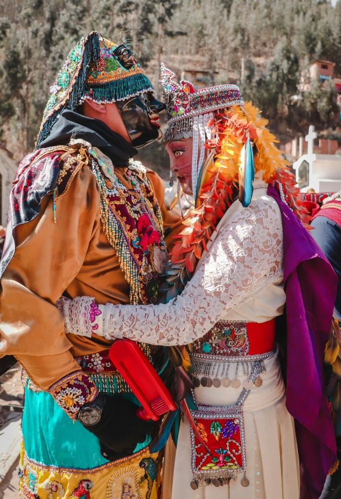 Two people in vibrant ceremonial costumes, showcasing the richness of cultural traditions in Mexico.